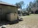 Backyard view showcasing a shed, green grass, and a screened-in pool area for outdoor relaxation at 10870 Sw 47Th Ct, Ocala, FL 34476