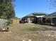 Spacious backyard with solar panels, a wood fence, and an enclosed screen patio at 10870 Sw 47Th Ct, Ocala, FL 34476