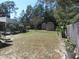 Spacious backyard featuring a pool area, multiple storage sheds, and lots of potential for custom landscaping at 10870 Sw 47Th Ct, Ocala, FL 34476