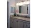 Bathroom features granite vanity, a decorative mirror and neutral decor at 10870 Sw 47Th Ct, Ocala, FL 34476