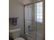 Bathroom with tub/shower with glass sliding door and glass block window at 10870 Sw 47Th Ct, Ocala, FL 34476