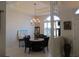 Open-concept dining room features an elegant chandelier and custom wall decor at 10870 Sw 47Th Ct, Ocala, FL 34476