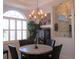 Elegant dining room features a decorative chandelier, large windows with shutters, and neutral tones at 10870 Sw 47Th Ct, Ocala, FL 34476