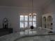 Chandelier-lit dining space, granite countertop, and shuttered windows at 10870 Sw 47Th Ct, Ocala, FL 34476