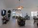 Bright living room featuring tile floors, high ceilings, a ceiling fan, and sliding glass doors to the sunroom at 10870 Sw 47Th Ct, Ocala, FL 34476