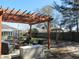 Backyard showing a pergola with seating and firepit next to the screened pool at 10870 Sw 47Th Ct, Ocala, FL 34476