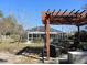 Outdoor pergola with seating area, adjacent to a screened pool, ideal for relaxing and entertaining at 10870 Sw 47Th Ct, Ocala, FL 34476