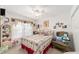 Charming bedroom with floral bedding and sitting chair at 11159 Sw 68Th Ct, Ocala, FL 34476