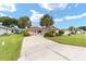 House exterior, palm trees and curved driveway at 11159 Sw 68Th Ct, Ocala, FL 34476