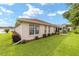 Tan house exterior with red roof and nicely landscaped yard at 11159 Sw 68Th Ct, Ocala, FL 34476