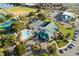 Aerial view featuring tennis courts, pool, and clubhouse at 11545 Se 175Th St, Summerfield, FL 34491