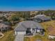 House with gray roof, stone pathway, and surrounding landscape at 11545 Se 175Th St, Summerfield, FL 34491