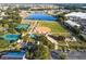 Aerial view showing sports fields, tennis courts, and a lake at 11545 Se 175Th St, Summerfield, FL 34491