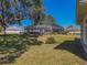 Backyard view showcasing a spacious lawn and screened enclosure at 11545 Se 175Th St, Summerfield, FL 34491