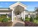 Entrance to community clubhouse with columns and holiday decor at 11545 Se 175Th St, Summerfield, FL 34491