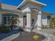 Front porch with red door and stone walkway at 11545 Se 175Th St, Summerfield, FL 34491