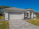 House with attached garage, stamped concrete driveway, and landscaping at 11545 Se 175Th St, Summerfield, FL 34491