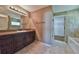 Bathroom with a double vanity, granite countertop, and tiled floors at 12177 Sw 96Th Ln, Dunnellon, FL 34432