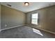 Well-lit bedroom with carpeted floor and a window offering natural light at 12177 Sw 96Th Ln, Dunnellon, FL 34432