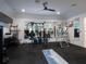 Spacious home gym featuring a variety of exercise equipment, mirrors, and natural light at 13061 Se 158Th Ln, Weirsdale, FL 32195