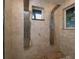 Luxurious shower is equipped with dual shower heads and travertine tile at 13061 Se 158Th Ln, Weirsdale, FL 32195