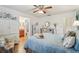 Bedroom with blue bedding, white armoire and en-suite bath at 1314 Noble Ct, Leesburg, FL 34788