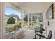 Cozy screened porch with wicker chairs and view at 1314 Noble Ct, Leesburg, FL 34788