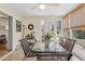 Bright sunroom features glass top table and chairs at 1314 Noble Ct, Leesburg, FL 34788