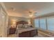 Primary bedroom with king bed, ceiling fan, and plantation shutters at 13579 Se 89Th Terrace Rd, Summerfield, FL 34491