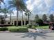 Community clubhouse with palm trees and golf cart at 13579 Se 89Th Terrace Rd, Summerfield, FL 34491