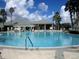 Large community pool with many swimmers at 13579 Se 89Th Terrace Rd, Summerfield, FL 34491