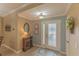 Bright and airy entryway with wood-look floors and a view to a bedroom at 13579 Se 89Th Terrace Rd, Summerfield, FL 34491