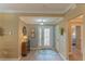 Bright and airy entryway with wood-look floors and a view to a bedroom at 13579 Se 89Th Terrace Rd, Summerfield, FL 34491