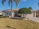 Attractive house exterior with tan walls, blue shutters, and nicely landscaped yard at 13579 Se 89Th Terrace Rd, Summerfield, FL 34491