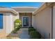 Front entryway features a decorative door and lush landscaping at 13579 Se 89Th Terrace Rd, Summerfield, FL 34491