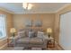 Well-lit guest room, featuring a sofa and stylish decor at 13579 Se 89Th Terrace Rd, Summerfield, FL 34491