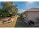 View of the home's back, highlighting a covered patio and nicely landscaped yard at 13579 Se 89Th Terrace Rd, Summerfield, FL 34491