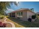 Back of house showcasing a large covered patio and well-maintained yard at 13579 Se 89Th Terrace Rd, Summerfield, FL 34491