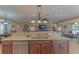 Island kitchen with granite countertops and stainless steel appliances at 13579 Se 89Th Terrace Rd, Summerfield, FL 34491