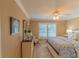 Bright main bedroom with a ceiling fan and plantation shutters at 13579 Se 89Th Terrace Rd, Summerfield, FL 34491