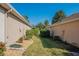 Landscaped side yard with gravel pathway between two house walls at 13579 Se 89Th Terrace Rd, Summerfield, FL 34491