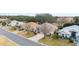 Aerial view of a residential street with houses and landscaping at 1397 Oak Forest Dr, The Villages, FL 32162