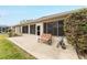 Back patio with bench and spacious concrete slab at 1397 Oak Forest Dr, The Villages, FL 32162