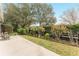 Landscaped backyard with lush greenery and wooden fence at 1397 Oak Forest Dr, The Villages, FL 32162