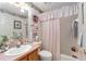 Pink bathroom with bathtub, toilet and wooden vanity at 1397 Oak Forest Dr, The Villages, FL 32162