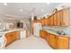 Well-equipped kitchen boasts ample wooden cabinetry and modern appliances at 1397 Oak Forest Dr, The Villages, FL 32162