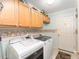 Laundry room with washer, dryer, and ample cabinet space at 1397 Oak Forest Dr, The Villages, FL 32162