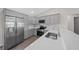 Modern kitchen with stainless steel appliances and gray cabinets at 14898 Se 35 Ct, Summerfield, FL 34491