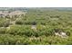 An aerial view of the house in the woods featuring a long driveway, and nestled homes at 15304 Sw 27 Ln, Ocala, FL 34481