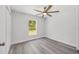 Bedroom with wood-look flooring, ceiling fan, and a window that provides plenty of natural light at 15304 Sw 27 Ln, Ocala, FL 34481